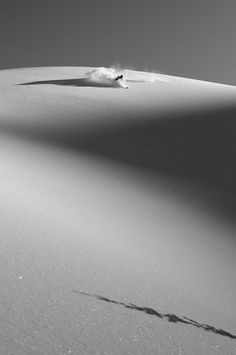 a person walking across a large white desert