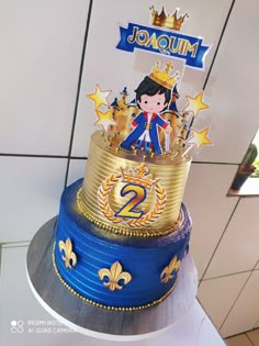 a blue and gold birthday cake with an image of a princess on top that says joaum