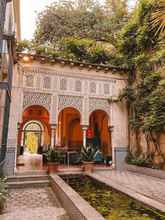 an outdoor courtyard with fountain and potted plants