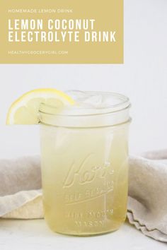 a mason jar filled with lemon coconut electrolyte drink on top of a table