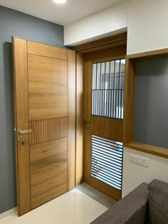 an empty room with a wooden door and blinds on the window sill in front of it