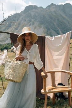 a woman standing next to a chair holding a basket