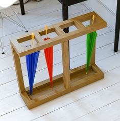 a wooden table with three umbrellas on it