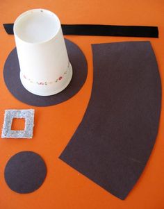 an orange table with some black and white items on it, including a paper cup