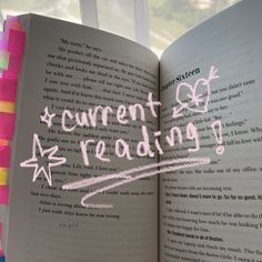 an open book with writing on it and the words current reading written in pink ink