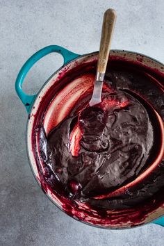 a blue pot filled with chocolate cake batter