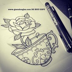 a drawing of a teapot with a rose on it next to a marker pen