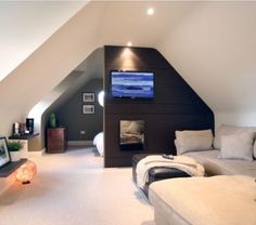 a living room filled with furniture and a flat screen tv mounted to the side of a wall