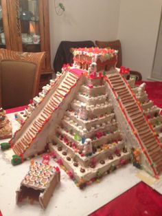 a very large pyramid made out of cookies and other items on a table in a room