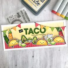 a card with taco on it next to markers and crayons