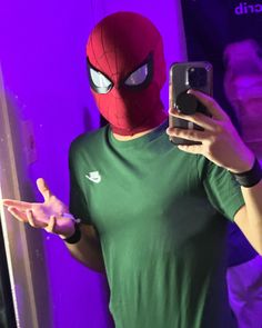 a person wearing a spider man mask taking a selfie