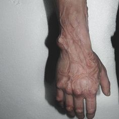 a person with tattoos on their arm and hand