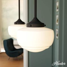 three lights hanging from a ceiling in a living room