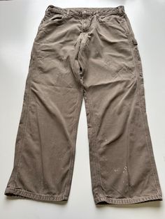 Mens Carhartt Baggy Carpenter Workwear Trouser / Pants 1990s vintage  Baggy Fit  Zip Fly  Light Brown Waist 35 inch Leg Length 29 inch **Sizes are exact measurement of the jean and may differ from the tag size** Please note due to the nature of these being workwear jeans there will be cool signs of fraying / paint and fading marks. All adding to the character of the piece** Item in great workwear condition overall Carhartt Baggy Pants, Vintage Brown Work Pants With Pockets, Corduroy Carpenter Pants, Brown Carpenter Pants, Carhartt Carpenter Jeans, Pantalon Carhartt, Workwear Jeans, Carpenter Pants, Workwear Trousers