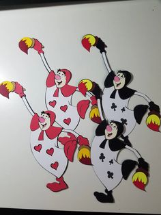 two clowns are dancing with hearts on their hands