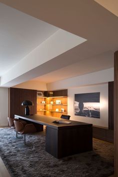 an office with a desk, chair and bookcase in the middle of the room