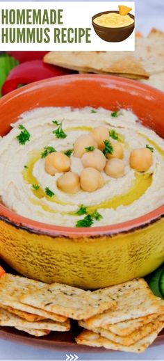 hummus in a bowl surrounded by crackers and vegetables with the text homemade hummus recipe