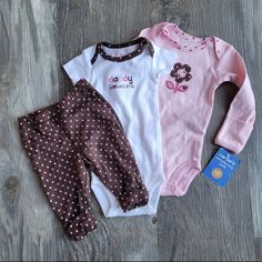 3 Piece Daddy Loves Me Set, Includes Chocolate And Pink Polka Dot Pants With Cuff At Ankle, A Short Sleeve Onesie With Embroidery And A Long Sleeve Onesie With Flower And Scratch Mittens! Fitted Cute Cotton Sets, Playful Pink Cotton Pants, Cute Pink Cotton Pants, Fitted Cute Pink Pants, Cute Fitted Pink Pants, Cute Pink Fitted Pants, Pink Cotton Pants For Playtime, Pink Cotton Playwear Pants, Cute Pink Bottoms For Playtime