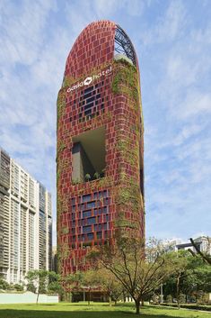 the building is made out of red bricks and has plants growing on it's side