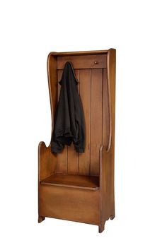 a wooden bench with a coat hanging on it's back and a black blanket draped over the seat