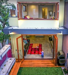 an aerial view of a house from the outside, looking down at the yard and patio