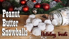 a wooden cutting board topped with snowballs next to christmas decorations