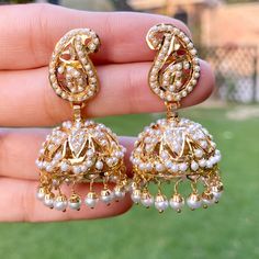 Featuring a pair of traditional pearl jhumkis in 22ct gold. The earrings weigh 22.82 GMs including 2.16 GMs of hanging pearls. Elegant Chandbalis For Eid Ceremonies, 22k Yellow Gold Pearl Drop Earrings, Elegant Jhumkas For Ceremonial Festivals, Ceremonial Gold Plated Jhumkas, Formal Festive Jhumkas With Latkans, 22k Gold Elegant Jhumkas With Meenakari, 22k Gold Meenakari Jhumkas In Elegant Style, Ceremonial Gold Plated Jhumkas With Latkans, Elegant Yellow Gold Jhumkas For Ceremonial Occasion