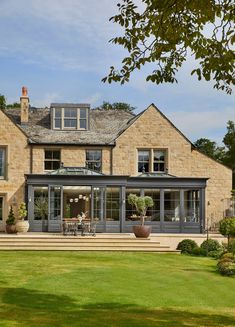 a large brick house with an outdoor dining area