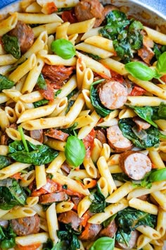 pasta with sausage and spinach in a pan