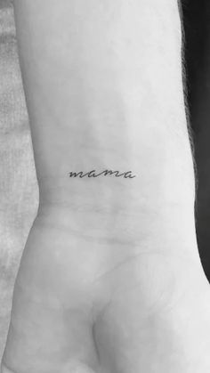 a person with a small tattoo on their wrist that reads,'mama'in cursive writing