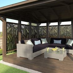 an outdoor living area with couches and tables