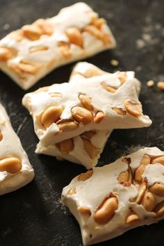 some kind of food that is on a table with almonds and white icing