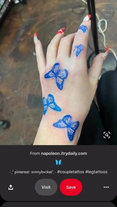 a woman's hand with blue butterflies painted on it