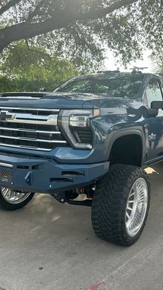 a large blue truck parked in a parking lot