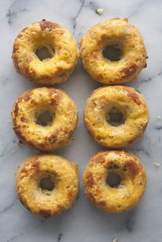 six mini pastries sitting on top of a marble counter