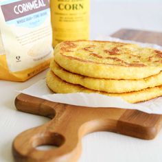 some food is sitting on a cutting board next to a bag of cornmeal