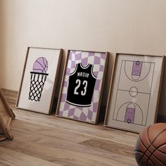 three framed sports posters on the wall next to a basketball