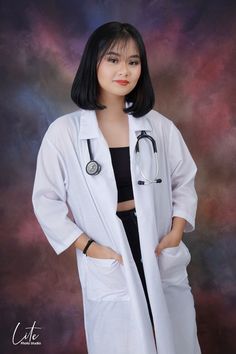 a woman in white lab coat posing for a photo