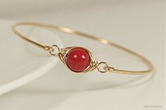 Wire Wrapped Red Coral Swarovski Pearl Bracelet Handmade by Jessica Luu Jewelry ~ Sophisticated ~ Versatile ~ Elegant ~ Perfect for everyday wear, this bangle adds a touch of casual elegance to every occasion - available in 2 metal choices. MATCHING ITEMS https://www.etsy.com/shop/JessicaLuuJewelry?search_query=red+coral+pearl MATERIALS: ~ 10mm red coral Swarovski pearl ~ 14K yellow or rose gold filled wire HOW IT'S MADE: A large Swarovski pearl is wire wrapped in a herringbone style then attach Red Coral Bracelet, Red Hand Wrapped Bracelets, Elegant Red Adjustable Bangle, Elegant Handmade Red Bangle, Elegant Red Handmade Bangle, Red Adjustable Wire Wrapped Bracelets, Adjustable Red Wire Wrapped Bracelets, Adjustable Red Wire Wrapped Bracelet, Coral Ring Designs For Women