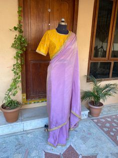 lavender tissue  silk saree with hand embroidery blouse |traditional saree with banarasi readymade blouse | sarees USA | pure light weight silk saree / blue saree with stitched blouse / voggish / elbow sleeve maggam blouse      you are absolutely gonna fall in love with this classic saree look with our stitched ready to wear blouses(includes the price) with a modern touch to them is perfect for your upcoming saree occassion that really makes you stand apart in crowd !!     You dont really need to stress your self in finding matching blouses for our sarees !! we pretty much carry our sarees with trendy stitched blouses or we will help you with our mix and match collection !!      Its a beautiful simple trending lavender tissue  silk saree finished with yellow color hand work lace paired wit Purple Raw Silk Pre-draped Saree With Cutdana, Purple Pre-draped Saree With Dori Work, Fitted Tussar Silk Saree With Dori Work, Unstitched Purple Cotton Silk Saree, Purple Unstitched Cotton Silk Saree, Purple Semi-stitched Cotton Silk Saree, Designer Raw Silk Purple Saree, Designer Purple Raw Silk Pre-draped Saree, Purple Cotton Silk Saree With Cutdana