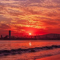 the sun is setting over an ocean with waves