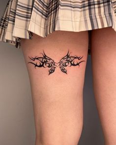 a woman's legs with tattoos on them and the bottom part of her leg