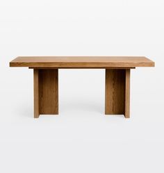 a wooden table sitting on top of a white floor