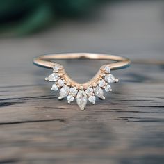 a close up of a ring on a wooden surface with water droplets and small white stones