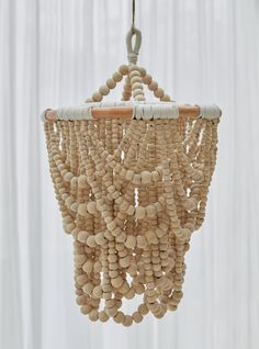 a wooden beaded chandelier hanging from a ceiling