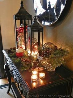 a table with candles and christmas decorations on it