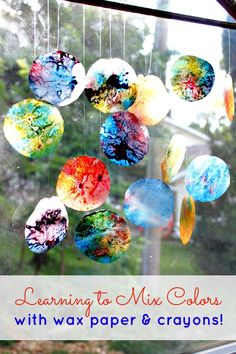 a wind catcher made with wax paper and crayons is shown in front of a window