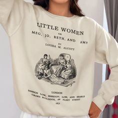 Introducing the must-have piece for all bookworms, literature lovers, and Little Women fans - the Little Women sweatshirt! This unique and stylish sweatshirt features original illustration and the first page of Chapter 1 on the back. If you are a Little Women lover or simply appreciate classic literature, this sweatshirt is a must-have addition to your wardrobe. Featuring a one-of-a-kind design, this Little Women sweatshirt showcases a special touch with the first page of Playing Pilgrims Chapte Bookish Sweatshirt With Letter Print And Crew Neck, Bookish Crew Neck Top With Character Print, Bookish Cotton Sweatshirt With Letter Print, Literary Long Sleeve Tops With Letter Print, Cotton Letter Print Bookish Sweatshirt, Literary Long Sleeve Cotton Tops, Relaxed Fit Crew Neck Bookish Sweatshirt, Bookworm Gifts, Literary Shirts