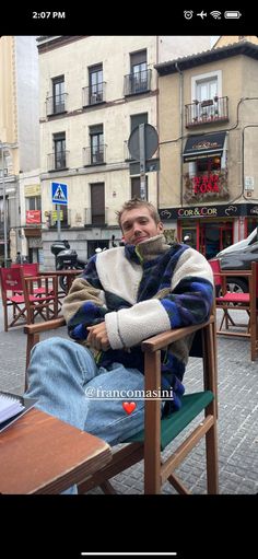 a man sitting in a chair on the street