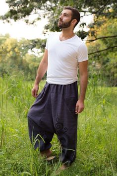 The asymmetric patterns on each side of the legs make this model unique. The swirls give a sense of freedom and movement which is felt when wearing this piece. With a strong Asian identity and a characteristic low crotch cut, our tribal pants have elastic at the ankles and an adjustable drawstring waist. These pants are handmade by the rural communities we support in northern Thailand where the designs are made, the cotton is farmed and the material is sewn together to produce this unique m Casual Drop Crotch Pants For Festival, Pretty Pants, Thai Pants, Thailand Fashion, Hippie Pants, Northern Thailand, Baby Shower Food, Hippie Outfits, Drawstring Waist